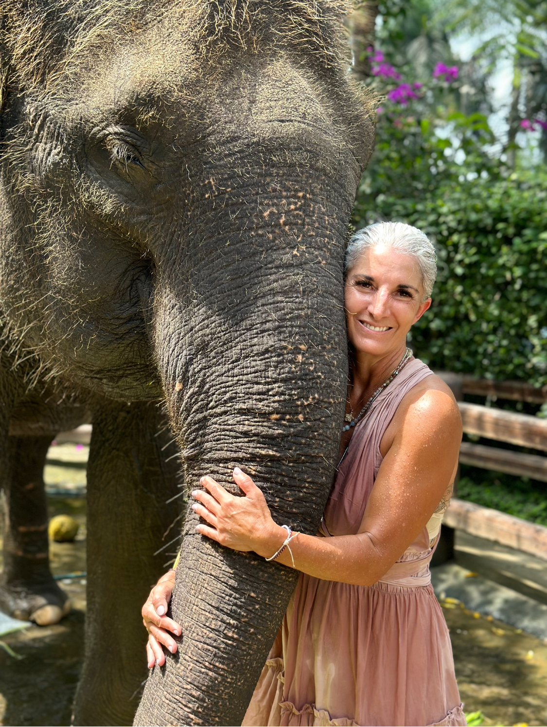 Armanda standing close to an elephant outdoors