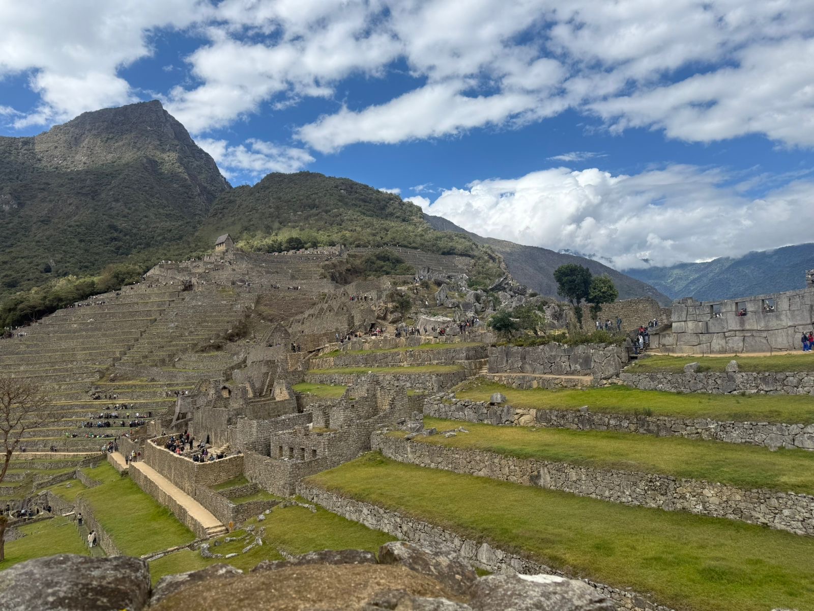Stone terraces stepping across a green mountainside beneath clouds